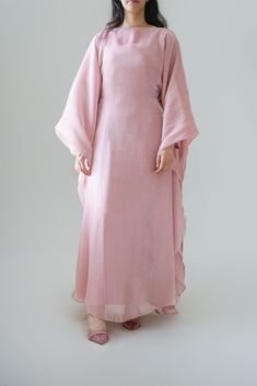 Indulge in our new Luxury silk Kaftan, part of our newest collection. A beautiful rose quartz shade that would look perfect for any occasion. The kaftan can be tied with the inner belt or styled with a loose fit (as shown in pictures) can be worn from a size S - XL. This Kaftan comes with a under layer dress Width: 60cm  This design comes in three shades; Rose Quartz, Cream, Lavender. * model is 5 ft 6 * material:  Premium silk Organza * fabric can differ due to lighting and also production whil Abaya Party Dress, Party Dress Modest, Party Abaya, Eid Abaya, Modest Abaya, Butterfly Abaya, Kaftan Abaya, Dress Modest, Silk Kaftan