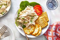 a white plate topped with salad and crackers