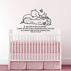 a winnie the pooh wall decal in a baby's room with pink walls