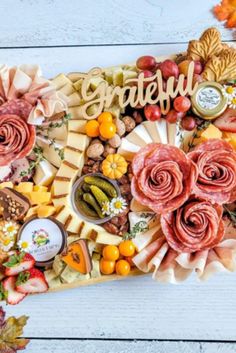 an assortment of cheeses, meats and vegetables arranged in the shape of a map