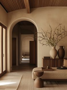 a living room filled with furniture and vases