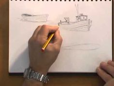 a person is drawing a boat on a sheet of paper while holding a pencil in their left hand