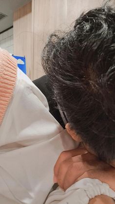 a man holding a baby in his arms while wearing a white shirt and black tie