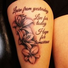 a woman's thigh with flowers on it and the words learn from yesterday live for today hope for tomorrow