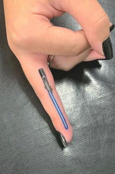 a woman's hand with a black and blue manicure on her left thumb