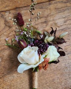 a bouquet of flowers sitting on top of a wooden table