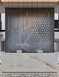 the front desk of aswar is surrounded by white marble and gold chandeliers