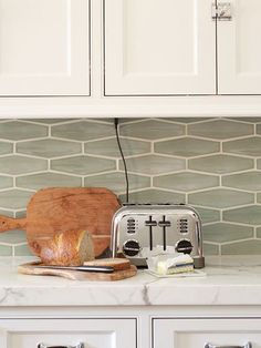 a toaster sitting on top of a counter next to a cutting board and knife