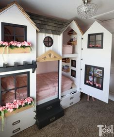 a room filled with lots of bunk beds covered in pink and white furniture next to a chandelier