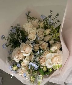 a bouquet of white roses and blue flowers