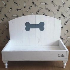 a white wooden bed with a dog bone on it