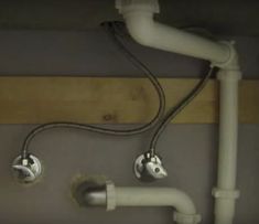 two white pipes connected to each other in a room