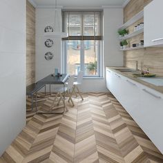 a modern kitchen with wood flooring and white cabinets, along with a dining table