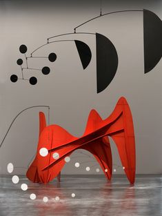 an abstract sculpture with black and red shapes