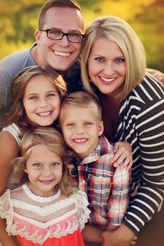 the family is posing for a photo together