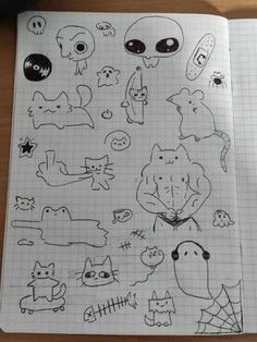 an open notebook with various stickers and drawings on the pages, including cats and dogs