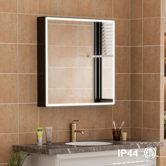 a bathroom sink sitting under a mirror next to a tiled wall