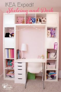 a white desk sitting in front of a book shelf filled with books and stuffed animals