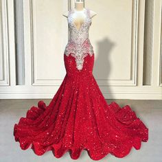 Unveil your inner goddess with our exquisite Red Sequin Mermaid Gown. This stunning masterpiece is meticulously adorned with shimmering sequins that catch the light with every movement, creating a dazzling effect that ensures you wont go unnoticed. The deep V-neckline and intricate beaded detailing at the bodice add a touch of elegance and sophistication, making it the perfect choice for any grand event or special occasion.The mermaid silhouette hugs your curves in all the right places, flaring out into a dramatic train that glides gracefully behind you. Designed to make a statement, this gown features a fitted bodice that enhances your natural shape, providing both comfort and a flattering fit. The luxurious fabric and quality craftsmanship ensure that youll look and feel your best from t Glamorous Rhinestone Mermaid Wedding Dress, Red Gown For Pageant During Prom Season, Glamorous Mermaid Dress With Sweep Train For Pageant, Elegant Red Glitter Dress, Glamorous Sequin Mermaid Hem Dress For Wedding, Rhinestone Mermaid Hem Gown For Prom, Glamorous Sequin Mermaid Hem Wedding Dress, Mermaid Sequin Dress For Wedding And Prom, Glamorous Sequin Wedding Dress With Mermaid Hem