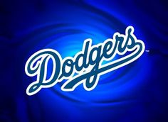 the dodgers logo is lit up against a blue background