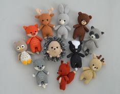 a group of stuffed animals sitting next to each other on a white surface with grey background