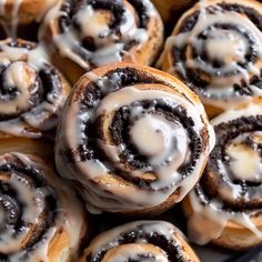 there are many cinnamon rolls with icing on them