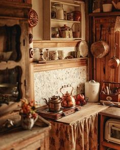 an old fashioned kitchen with pots and pans on the stove