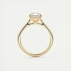 a yellow gold engagement ring with an oval cut diamond