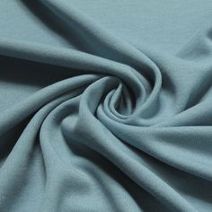 a close up shot of the fabric on a blue shirting material, which is very soft