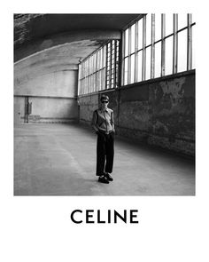 a black and white photo of a man standing in an empty room with the words celline on it