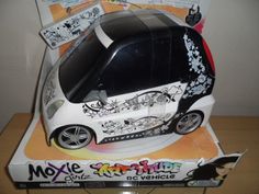 a white toy car with graffiti on it's side in a cardboard display case