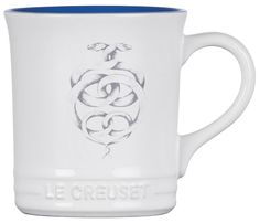 a white and blue coffee mug with the words le creuset printed on it