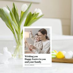 a woman holding a baby in her arms with a card saying wishing you happy easter to you and your family