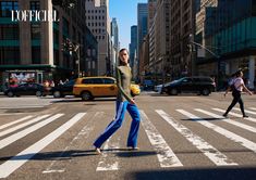 a woman is crossing the street in new york city