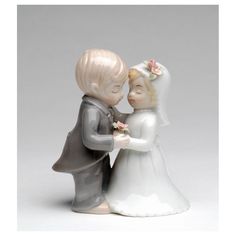 a ceramic figurine of a bride and groom kissing