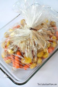 a plastic bag filled with carrots and potatoes