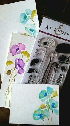 some cards with flowers and scissors on them