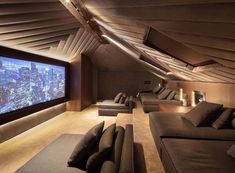 a room with couches and a large screen