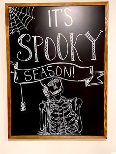 a chalkboard with the words it's spooky season written on it