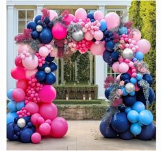 an arch made out of balloons and flowers