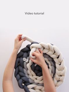 a woman is holding a large rope with two hands and the text video tutor above it