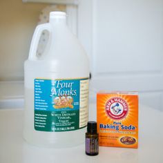 a bottle of baking soda next to a container of baking soap and an orange packet