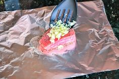 a piece of salmon on top of some foil with a fork