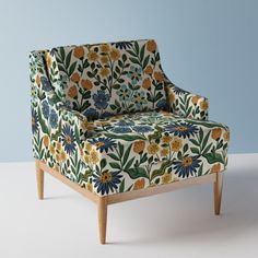 an upholstered chair with colorful flowers on it