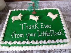 a green sheet cake with white sheep on it that says thank ewe from your little flock