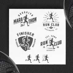 the logos for marathon run club are displayed on a piece of paper next to running shoes