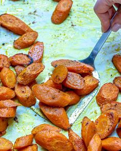 someone cutting up sweet potatoes with a knife