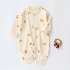 Be the cutest baby around in this Fun and Cozy Cartoon Bear Romper. This romper will keep your baby warm and cozy all day long while bringing a smile to everyone's face with its irresistibly cute design. Get ready to stand out from the crowd! Introducing the Unisex Cartoon Romper, designed for fun and comfort. Made from soft and breathable cotton, it's perfect for spring and autumn wear. Featuring a charming cartoon pattern, this romper adds a touch of cuteness to your baby's wardrobe. Equipped Cream Cotton Onesie For Playtime, Cream Cotton Playtime Onesie, Cream Long Sleeve Onesie For Bedtime, Long Sleeve Onesie With Cartoon Print For Playtime, Family Matching Long Sleeve Onesie For Playtime, Winter Cotton Bubble Romper With Long Sleeves, Playful Cream Cotton Onesie, Cream Long Sleeve Onesie For Loungewear, Playful Long Sleeve Jumpsuits And Rompers For Playtime