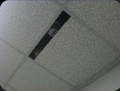 the ceiling in an office building is decorated with black and white speckles on it