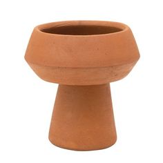 a large clay vase sitting on top of a table